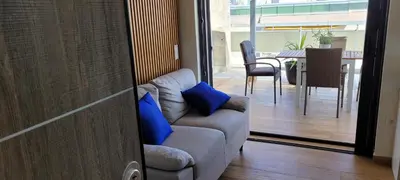 a living room with a couch with blue pillows at The Penthouse in Athens