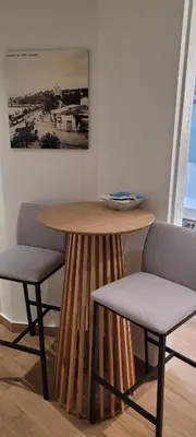 a wooden table and two chairs in a room at The Penthouse in Athens