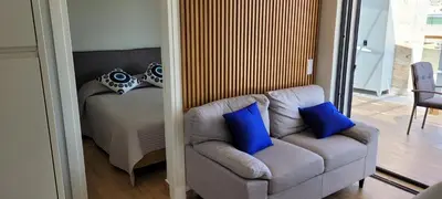 a living room with a couch and blue pillows at The Penthouse in Athens