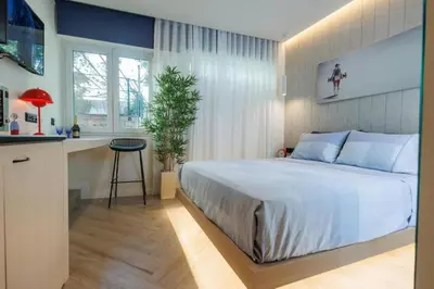 a bedroom with a large bed and a kitchen at Triple A - Psiri Nightlife at Theatrou Square - Urban Studios - FREE Parking! in Athens