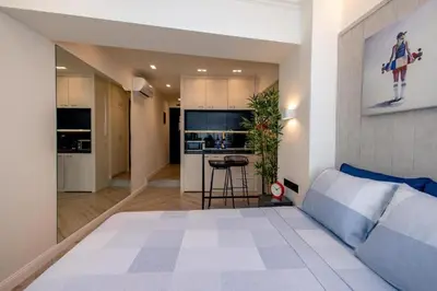 a bedroom with a large bed and a kitchen at Triple A - Psiri Nightlife at Theatrou Square - Urban Studios - FREE Parking! in Athens