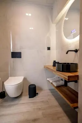 a white bathroom with a toilet and a sink at Triple A - Psiri Nightlife at Theatrou Square - Urban Studios - FREE Parking! in Athens