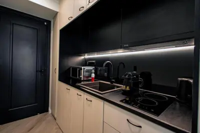 a kitchen with a sink and a black wall at Triple A - Psiri Nightlife at Theatrou Square - Urban Studios - FREE Parking! in Athens