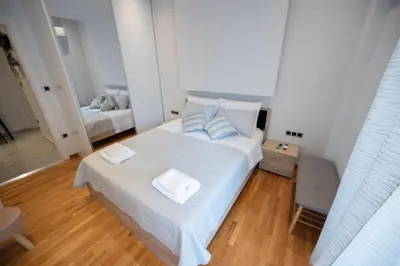 a bedroom with a white bed with two towels on it at Athens Modern Hub in Athens