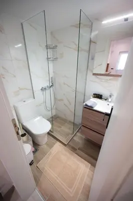a bathroom with a toilet and a shower and a sink at Athens Modern Hub in Athens