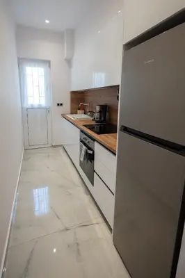a kitchen with a refrigerator and a counter top at Athens Modern Hub in Athens