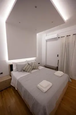 a bedroom with a large bed with two towels on it at Athens Modern Hub in Athens