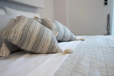a white bed with pillows on top of it at Athens Modern Hub in Athens