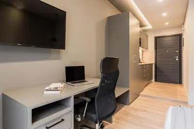 an office with a desk with a laptop and a chair at WYZ Museum by UPSTREET in Athens