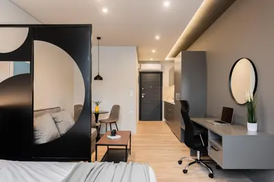 a bedroom with a bed and a desk and a desk at WYZ Museum by UPSTREET in Athens