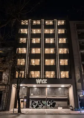a building with a sign on the front of it at WYZ Museum by UPSTREET in Athens