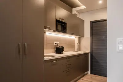 a kitchen with stainless steel cabinets and a sink at WYZ Museum by UPSTREET in Athens