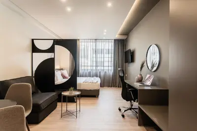 a hotel room with a bed and a desk at WYZ Museum by UPSTREET in Athens