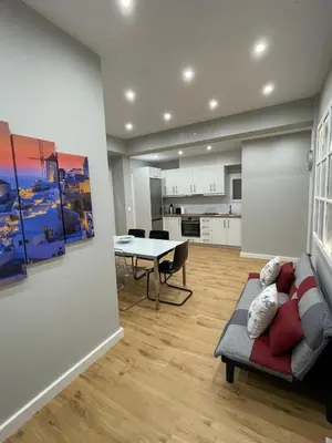 a living room with a couch and a table at FilOikos Privacy Nest Retreat 3Br 3Ba En-Suite in Athens