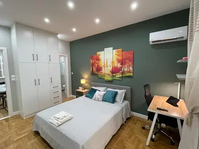 a bedroom with a bed and a desk in it at FilOikos Privacy Nest Retreat 3Br 3Ba En-Suite in Athens