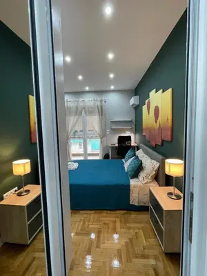 a bedroom with a blue bed and two lamps at FilOikos Privacy Nest Retreat 3Br 3Ba En-Suite in Athens