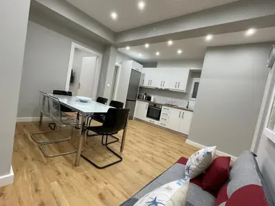 a kitchen and living room with a table and a couch at FilOikos Privacy Nest Retreat 3Br 3Ba En-Suite in Athens