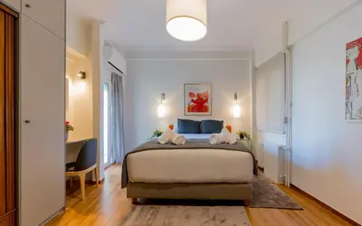 a bedroom with a bed with two towels at Mia Homes - Acropolis in Athens