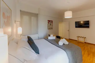 a bedroom with a large white bed with pillows at Mia Homes - Acropolis in Athens