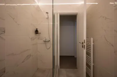 a bathroom with a shower with a glass door at Mia Homes - Acropolis in Athens