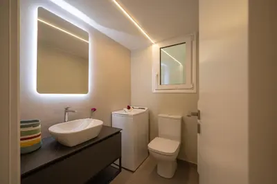 a white bathroom with a sink and a toilet at Mia Homes - Acropolis in Athens