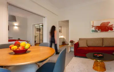 a woman in a living room with a bowl of fruit on a table at Mia Homes - Acropolis in Athens
