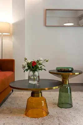 a coffee table with a vase of flowers on it at Mia Homes - Acropolis in Athens