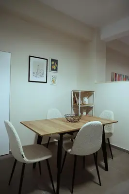a dining room with a wooden table and chairs at Heart of Athens Stay #5 in Athens
