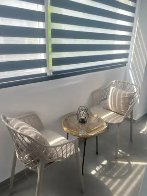 two chairs and a table in a room with windows at Heart of Athens Stay #5 in Athens