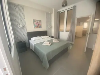 a bedroom with a bed with two towels on it at Heart of Athens Stay #5 in Athens