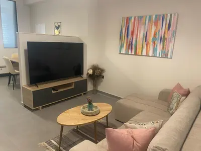 a living room with a couch and a tv at Heart of Athens Stay #5 in Athens