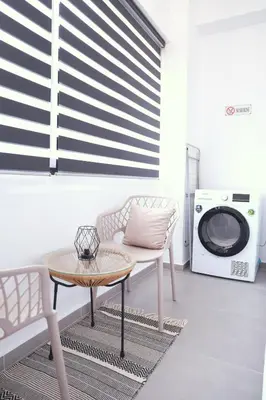 a living room with a table and a washing machine at Heart of Athens Stay #6 in Athens