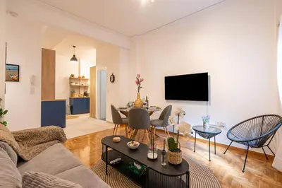 a living room with a couch and a table at Miss H Haven in Athens