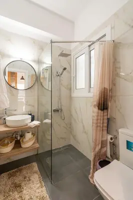 a bathroom with a shower and a toilet and a sink at Miss H Haven in Athens