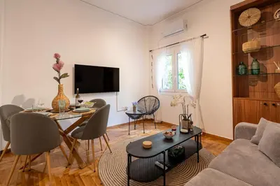 a living room with a couch and a table at Miss H Haven in Athens