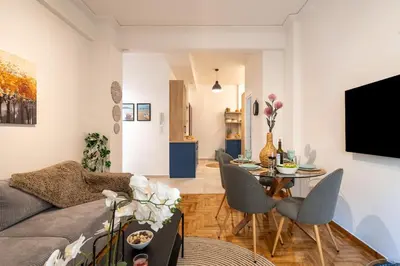 a living room with a couch and a table at Miss H Haven in Athens