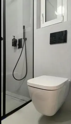 a bathroom with a white toilet and a shower at Sourmel Apt in Athens