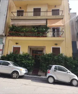 two cars parked in front of a building at Sourmel Apt in Athens