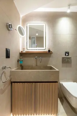a bathroom with a sink and a mirror and a toilet at Glyfada Coastside Apartment in Athens