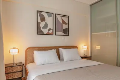 a bedroom with a white bed with two lamps at Casa Riviera-Newly Renov 2Br Luxury Apt near Sea in Athens