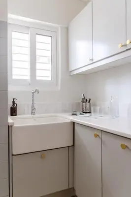 a white kitchen with a sink and a window at Casa Riviera-Newly Renov 2Br Luxury Apt near Sea in Athens