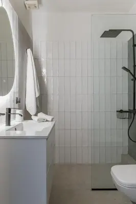 a white bathroom with a sink and a mirror at Casa Riviera-Newly Renov 2Br Luxury Apt near Sea in Athens