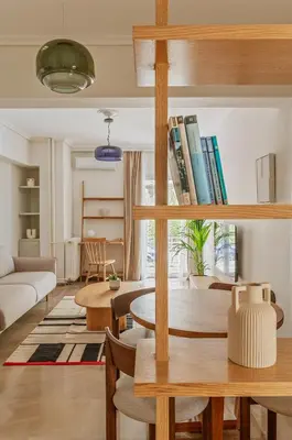 a living room with a couch and a table with books at Casa Riviera-Newly Renov 2Br Luxury Apt near Sea in Athens