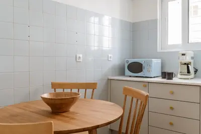 a kitchen with a table and chairs and a microwave at Casa Riviera-Newly Renov 2Br Luxury Apt near Sea in Athens