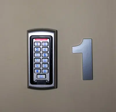 a remote control on a door with the number one at Athens Central Studios 1 in Athens