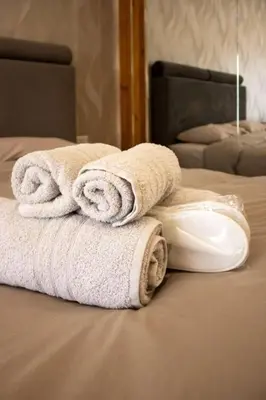 a pile of towels sitting on top of a bed at Athens Central Studios 1 in Athens