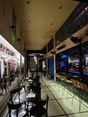 a restaurant with tables and chairs and a bar at Athens Central Studios 1 in Athens