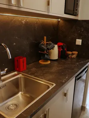 a kitchen with a sink and a counter top at Athens Central Studios 1 in Athens