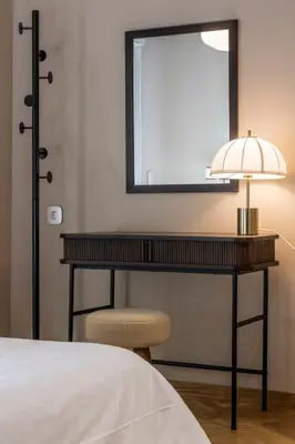a bedroom with a desk with a lamp and a chair at Immaculate Modern Kypseli Apt - Next to Kanari Sq in Athens