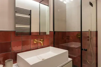 a bathroom with a white sink and a shower at Immaculate Modern Kypseli Apt - Next to Kanari Sq in Athens